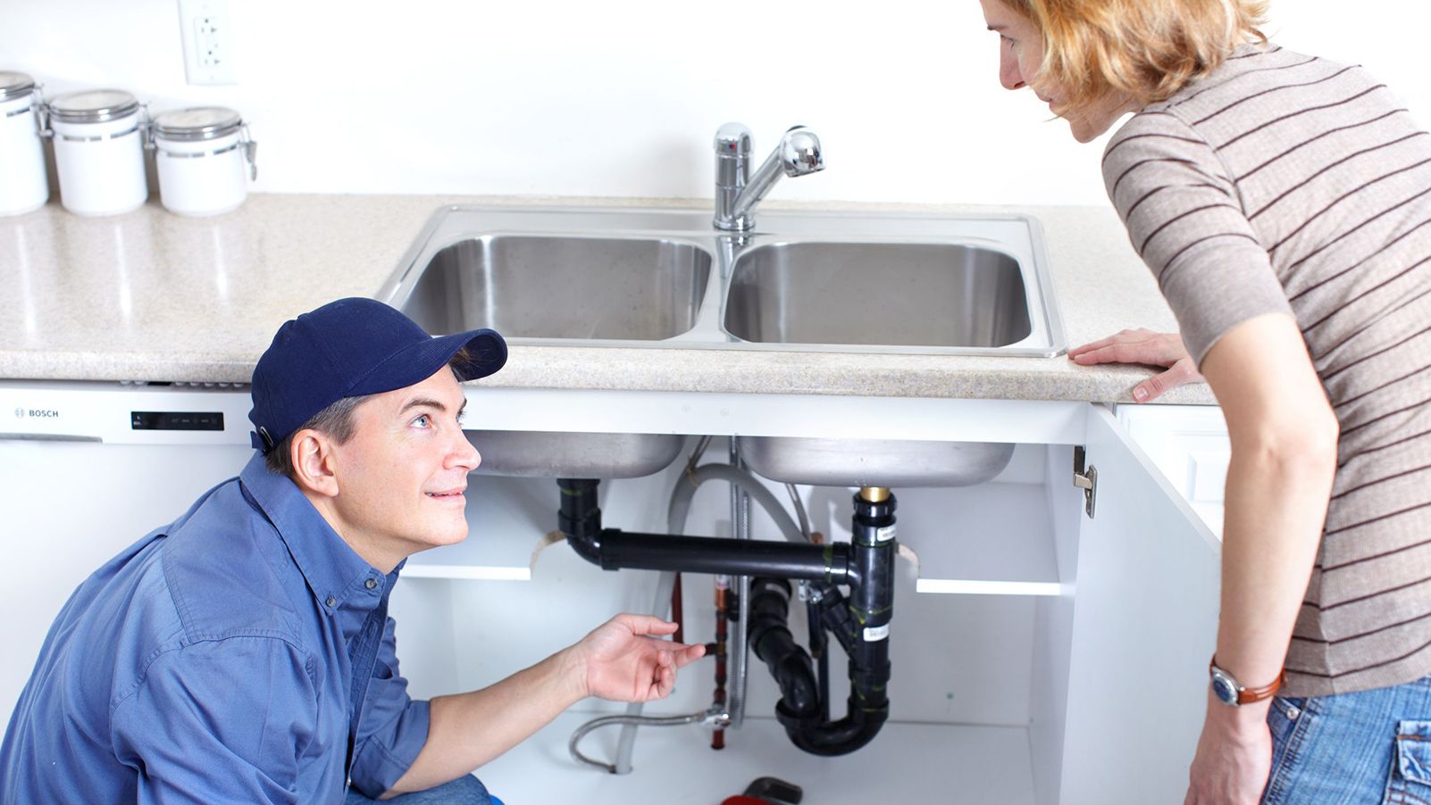 Technician working on garbage disposal