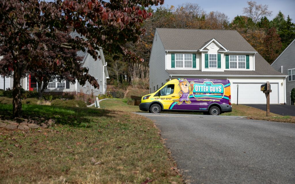 Otter van parked in front of a house.