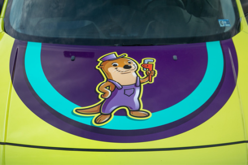 The Otter Guys logo on the front of the work van.