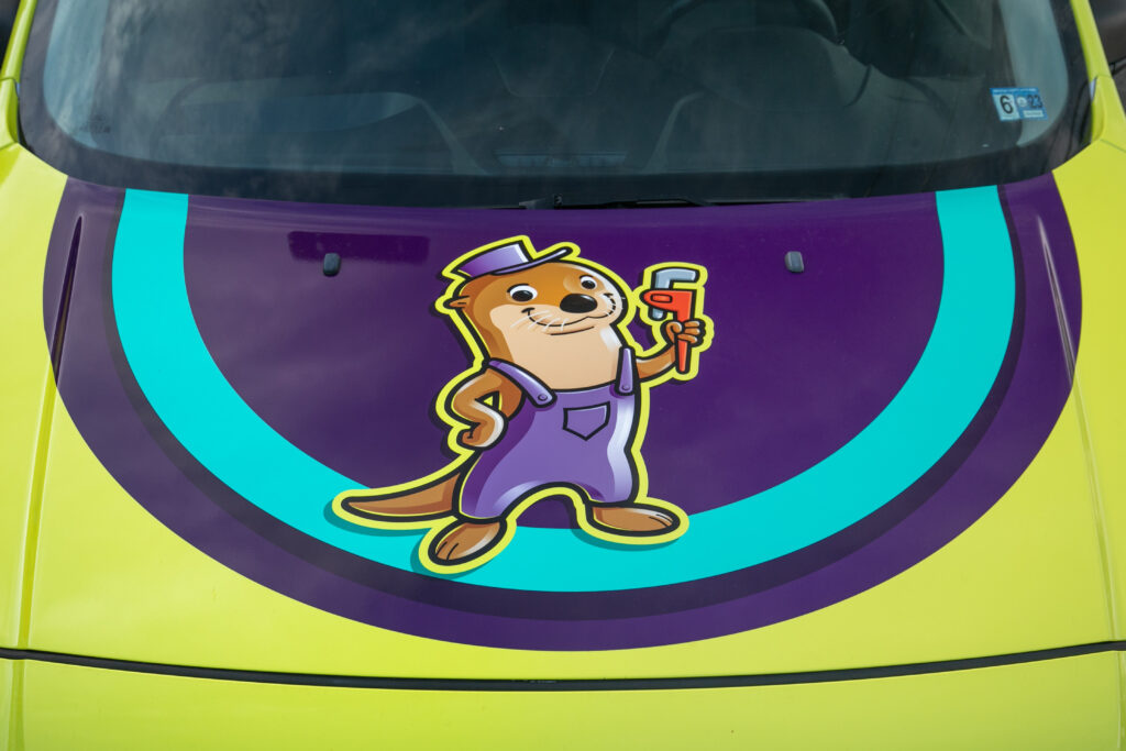 The Otter guys emblem on the front of the service van.