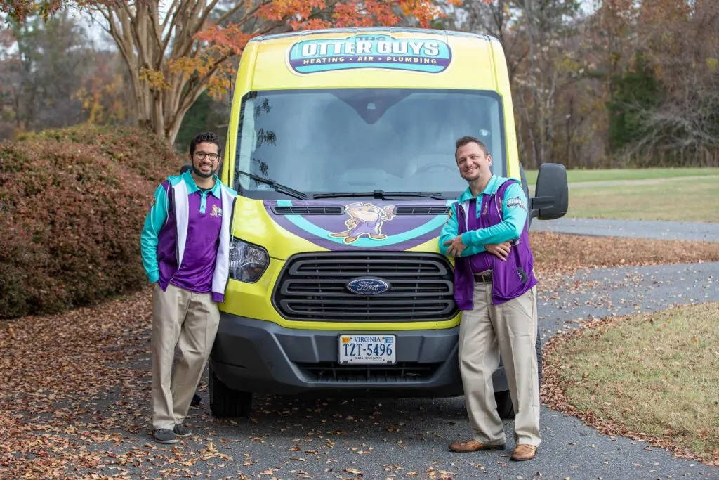 Otter employees standing in front of work van