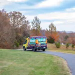 Otter van driving down the road.