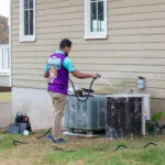 Otter employee cleaning the HVAC system.