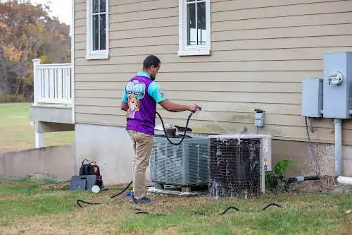Otter employee cleaning the HVAC system.