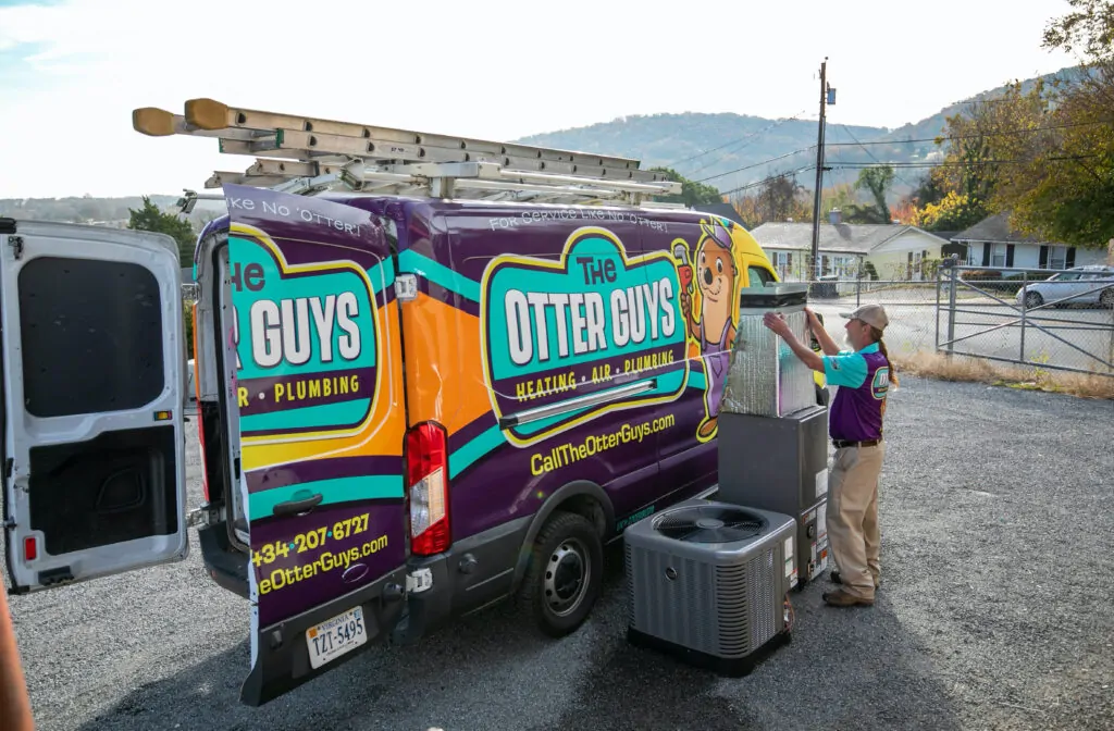 Otter Guys technician unloading HVAC system.