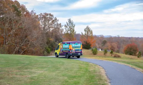 The Otter Guys van driving down the road.