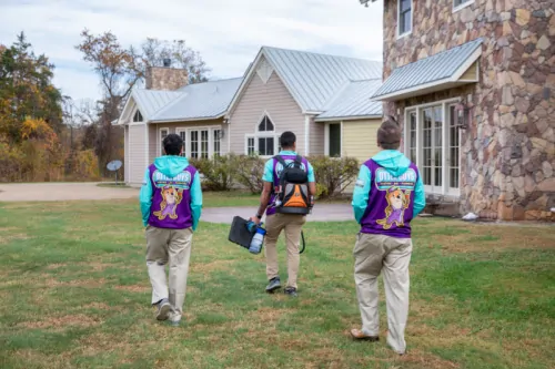 3 Otter employees walking across the yard.