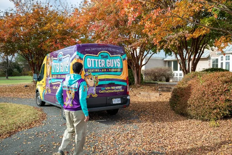 Service worker walking towards a house.
