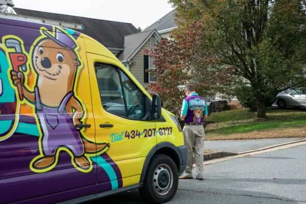 service man walking around the front of the truck