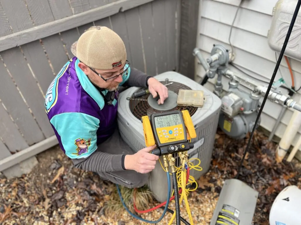 AC Repair Technician inspecting an Air Conditioner unit in Charlottesville, VA